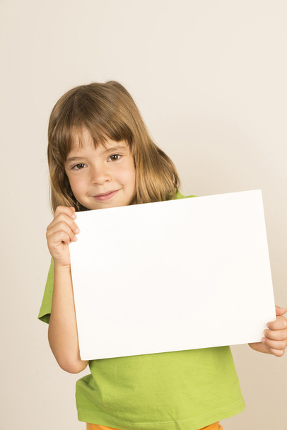 Little girl carrying a poster - Фото, зображення
