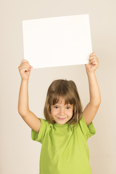 Little girl carrying a poster - Φωτογραφία, εικόνα