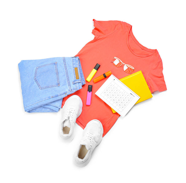 Female clothes, shoes, sunglasses and stationery on white background - Photo, image