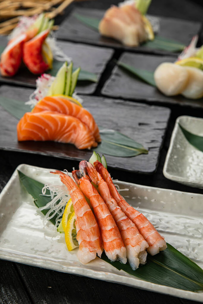 Assorted sashimi on a dark table - Valokuva, kuva