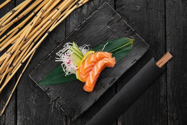 Assorted sashimi on a dark table - Фото, изображение