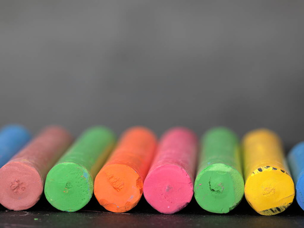 A row of colorful chalks on grey background. - Photo, Image