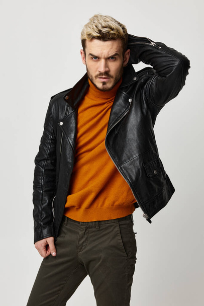 sexy man in leather jacket and pants orange sweater model - Photo, Image