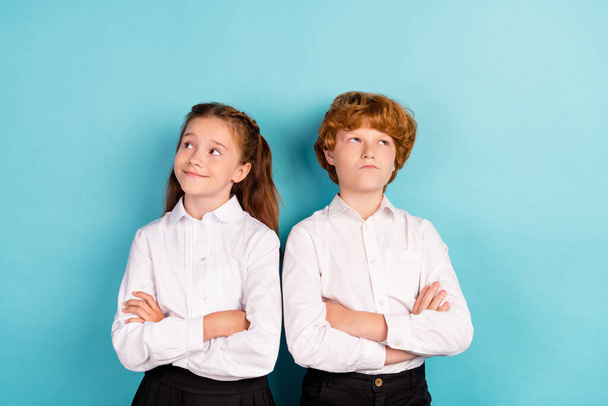 Portrait of two attractive pensive kids folded arms fantasizing isolated over bright blue color background - Zdjęcie, obraz