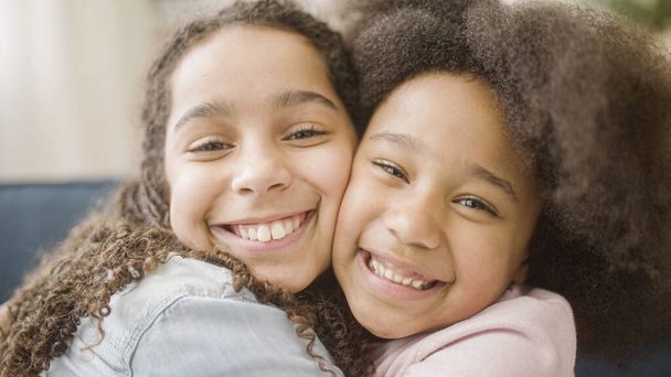 Loving black sisters hugging and smiling sincerely, family support and care - Fotoğraf, Görsel