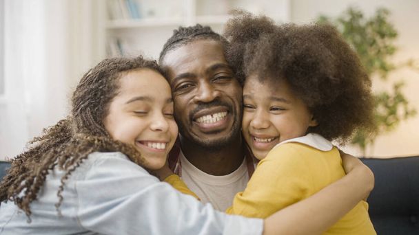 Happy black family of father and two daughters smiling on camera, support, care - Foto, afbeelding