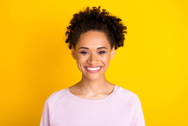 Photo of charming satisfied dark skin person have good mood look camera isolated on yellow color background - Foto, immagini