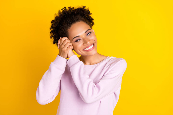 Portrait of pretty cheerful dark skin person arms folded touch head look camera isolated on yellow color background - Zdjęcie, obraz