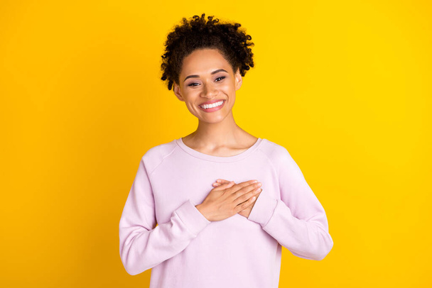 Photo of young happy afro american woman hold hands heart smile thankful isolated on yellow color background - Φωτογραφία, εικόνα