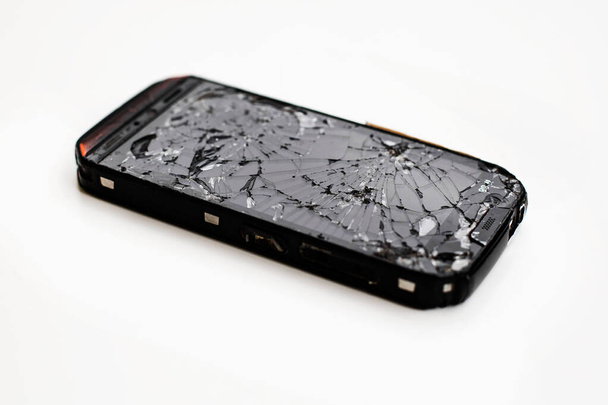 Мобільний смартфон з розбитим екраном ізольовано на білому
. - Фото, зображення