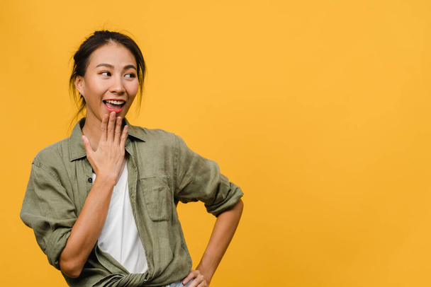 Portrait of young Asia lady with positive expression, smile broadly, dressed in casual clothing over yellow background. Happy adorable glad woman rejoices success. Facial expression concept. - Photo, Image