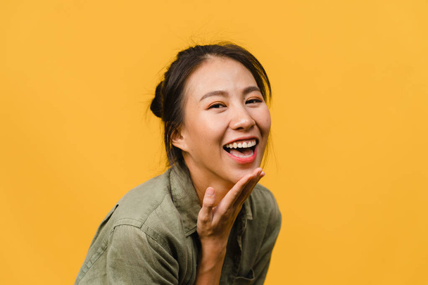 Young Asia lady with positive expression, smile broadly, dressed in casual clothing and looking at camera over yellow background. Happy adorable glad woman rejoices success. Facial expression concept. - Photo, Image