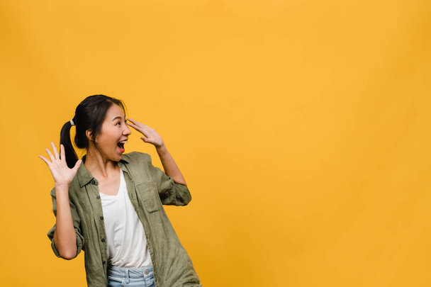 Young Asia lady feel happiness with positive expression, joyful surprise funky, dressed in casual cloth isolated on yellow background. Happy adorable glad woman rejoices success. Facial expression. - Фото, зображення
