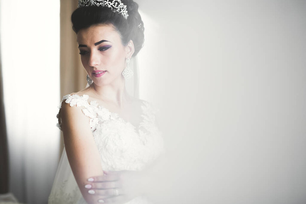 Luxury bride in white dress posing while preparing for the wedding ceremony - Foto, imagen