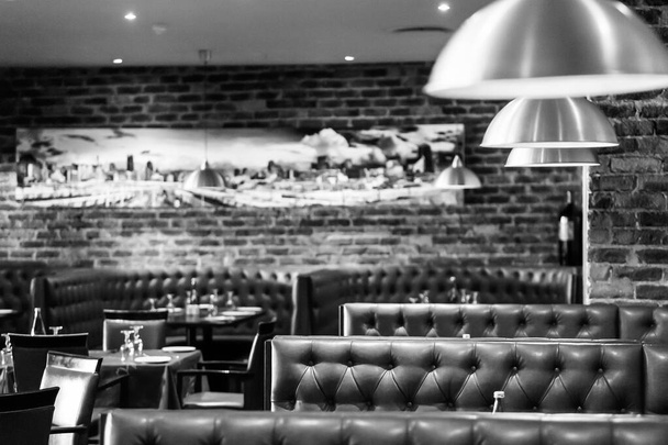 JOHANNESBURG, SOUTH AFRICA - Jan 05, 2021: A grayscale of an interior of booth style restaurant diner in Johannesburg, South Africa - Photo, Image
