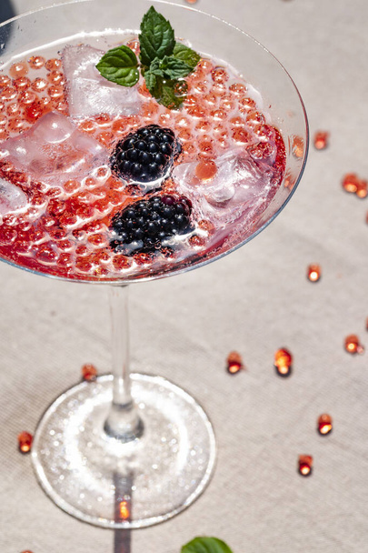 A vertical shot of delicious molecular cocktail with blackberries on a table - Foto, immagini