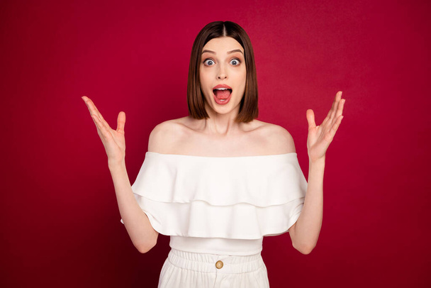 Photo of angry brown hairdo millennial lady hands up yell wear white bare shoulders top isolated on red color background - Foto, Imagem