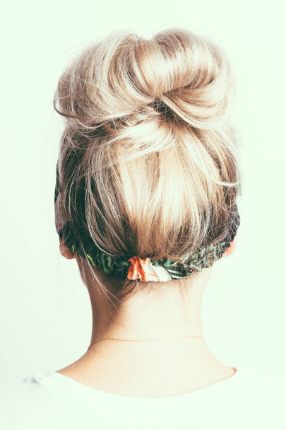 blondýnka s chomáčkem vlasů na hlavě, pohled zezadu - Fotografie, Obrázek