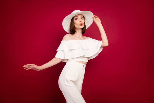 Photo portrait pretty brunette wearing hat dancing at party with pouted lips isolated red color background - Foto, Imagen