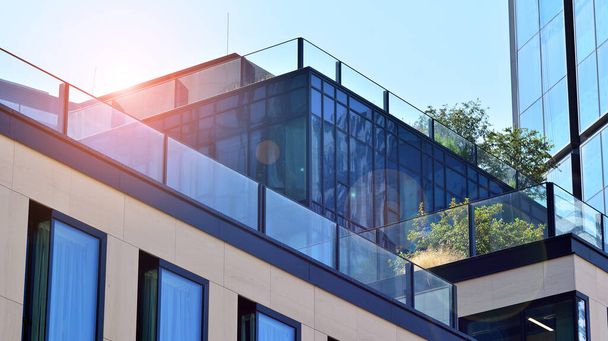 Modernes Bürogebäude aus Glas mit grünen Blättern. Ökologisches Bauen und Grünanlagen im Stadtkonzept. - Foto, Bild