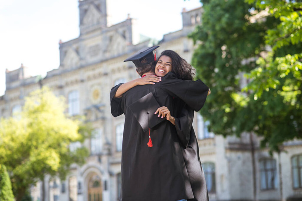 Friends hugging each other after graduation and feeling happy - Foto, Imagem