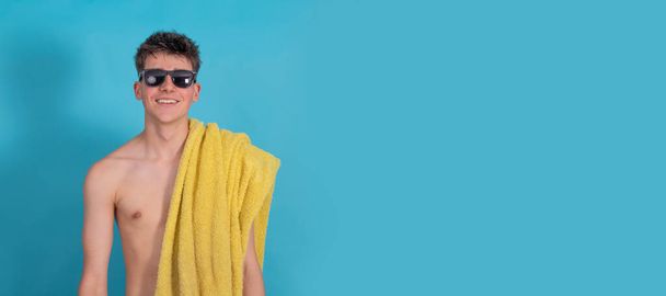 isolated teenager with sunglasses and towel, vacation and summer - Fotoğraf, Görsel