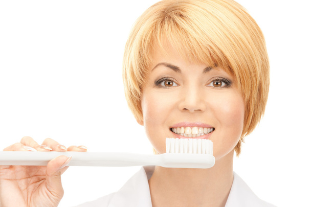 Picture of attractive female doctor with toothbrush - Foto, Imagem