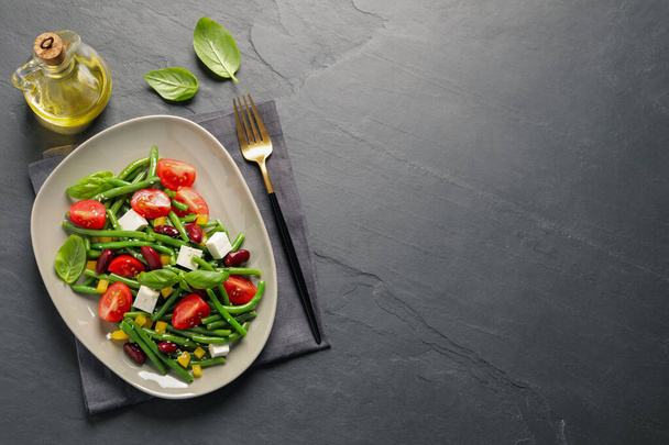 Tasty salad with green beans served on black table, flat lay. Space for text - Foto, Imagem