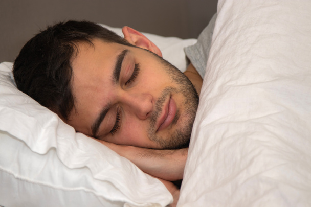 portrait young man sleeping in bed - Fotoğraf, Görsel
