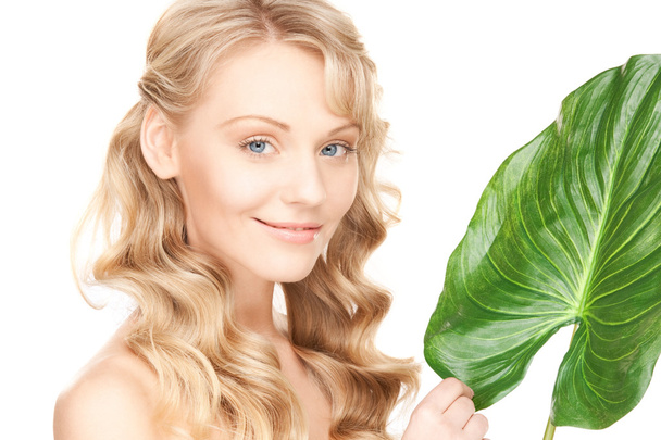 Picture of woman with green leaf over white - Photo, Image