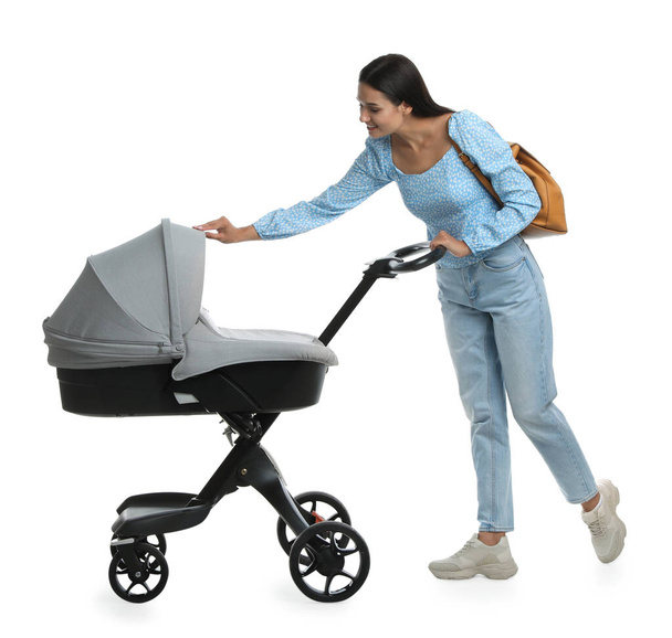 Happy young woman with baby stroller on white background - Foto, Imagem