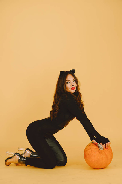 Woman with cat makeup and ears on color background - 写真・画像