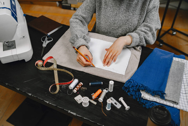 Professional young female tailor working in workshop - Fotografie, Obrázek