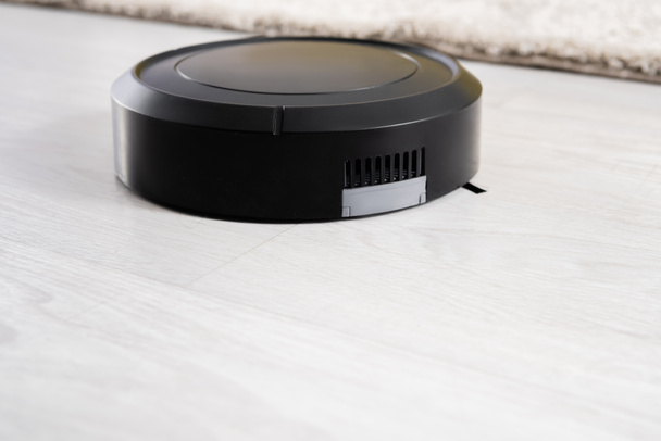 Close up view of robotic vacuum cleaner on floor  - Photo, Image
