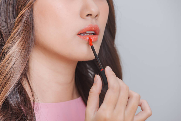 Cute girl applying lip gloss - Photo, Image