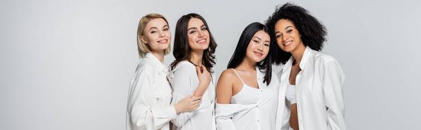 group of cheerful multiethnic models smiling isolated on grey, banner - Fotoğraf, Görsel