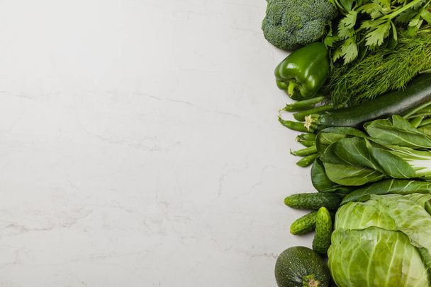 Stone background with a border of fresh vegetables.  Top view. - Φωτογραφία, εικόνα