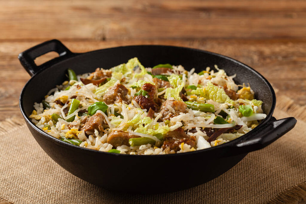 Fried veal, with rice, Chinese cabbage and mushrooms. Sprinkled with sesame and soy sauce. Front view.  - 写真・画像