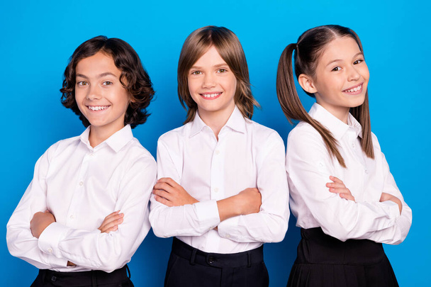 Photo of pretty charming schoolkids formalwear arms folded smiling isolated blue color background - Φωτογραφία, εικόνα