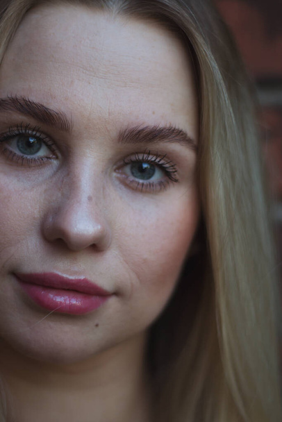 street portrait of young beautiful blonde woman with blue eyes woman close up, close-up. Natural evening light - Fotografie, Obrázek