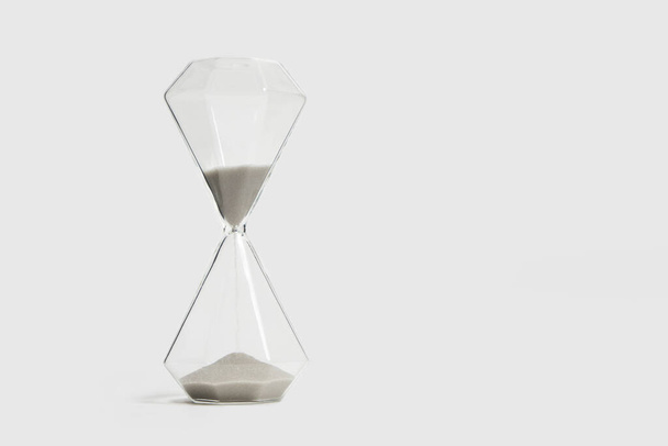 Hourglass on a white background, passing time - Фото, изображение
