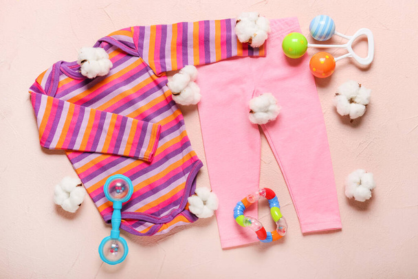 Tyylikäs vauvan vaatteita leluja värillinen tausta - Valokuva, kuva