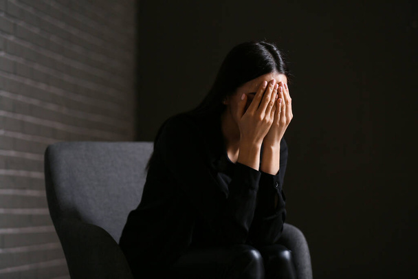 Junge depressive Geschäftsfrau im dunklen Büro - Foto, Bild