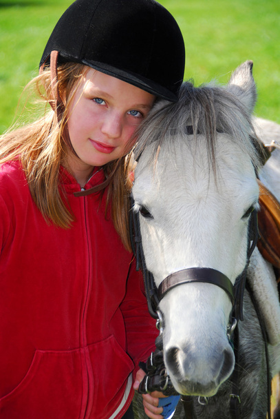 Portrait of a young girl with a white pony - Фото, зображення