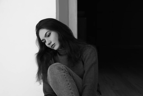 Black and while portrait of depressed young woman at home - Photo, Image
