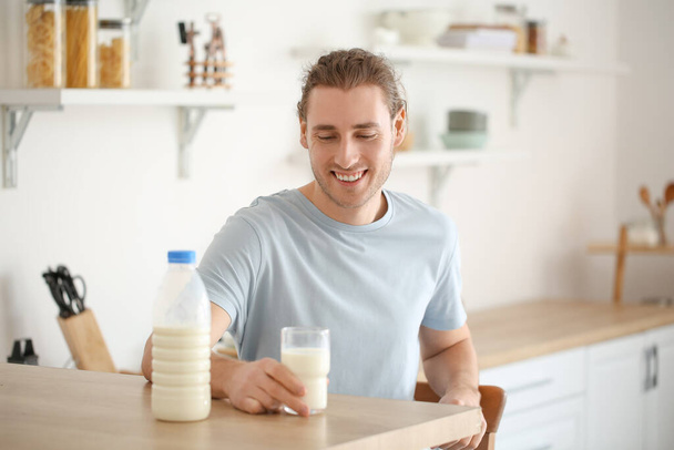 Joven con leche fresca en casa - Foto, imagen