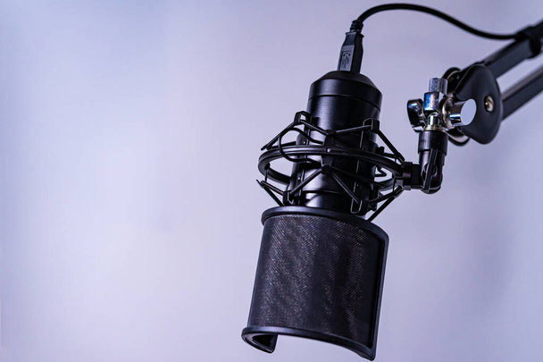 A closeup shot of a studio microphone against a purple background - Foto, immagini