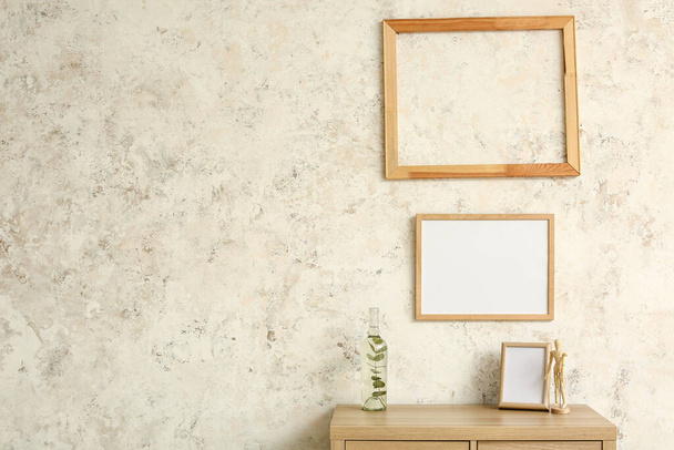 Wooden frames hanging on light wall - Foto, immagini