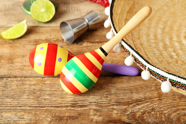 Mexican maracas, tequila and sombrero on wooden background - Photo, Image