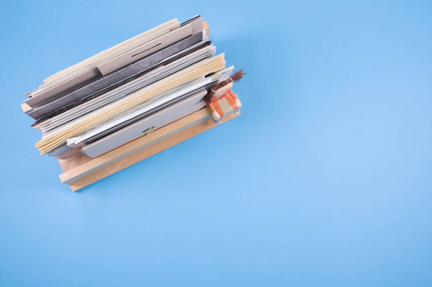 A top vof filled documents on a wooden shelf isolated on blue background - Foto, Imagen